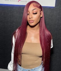 a woman with long red hair is posing for a photo